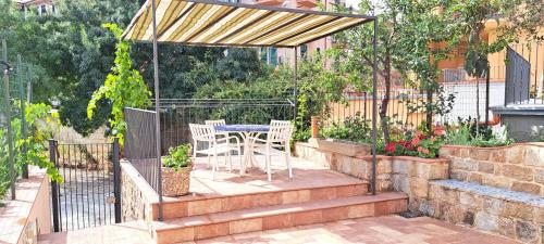 a patio with a table and chairs in a backyard at Casa Giulia in Castelbuono