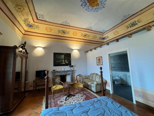 a bedroom with a bed and a couch and a fireplace at Villa Dell'Annunziata in Rieti