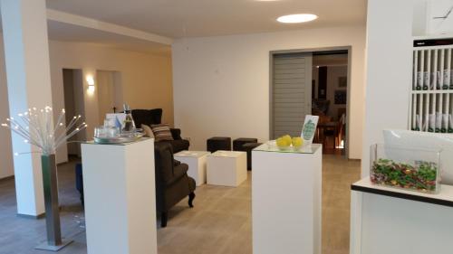 a living room with a couch and a chair at Waldhotel Brand's Busch in Bielefeld