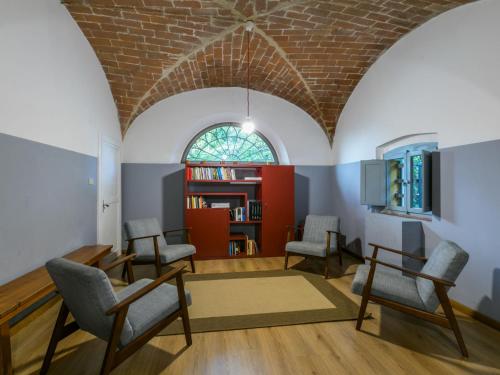 a living room with chairs and a brick ceiling at Holiday Home Pietra by Interhome in Lorenzana