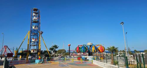 a amusement park with a roller coaster and rides at Marina smir Oceanica in Marina Smir
