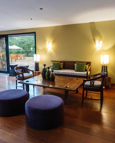 a living room with a couch and a table and chairs at Loi Suites Iguazu Hotel in Puerto Iguazú