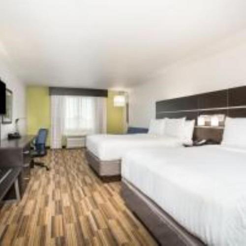 a large hotel room with a large bed and a desk at Holiday Inn Express & Suites - Rapid City - Rushmore South by IHG in Rapid City