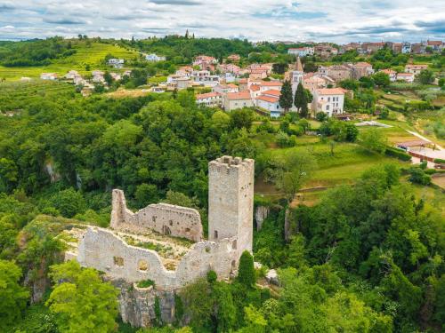 an old castle on a hill with a town in the background at Holiday Home Villa Samanta by Interhome in Momjan