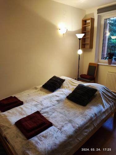 a bedroom with a large bed with two pillows on it at Diós Apartman Pécs in Pécs