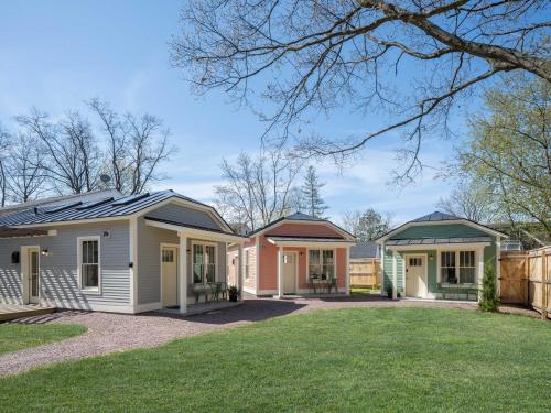 a row of houses with a green yard at Queen City Bungalow & Cottages in Burlington