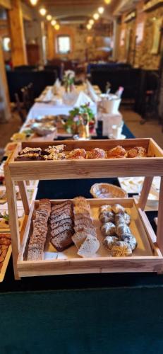 a table with several trays of different types of pastries at Pałac Spichrz in Borcz