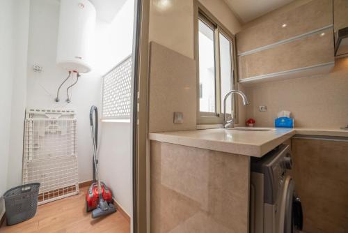 a kitchen with a sink and a window at Luxury Seafront Apartment 101sqm with 2 Bedrooms and Wi-Fi Unlimited in Agadir