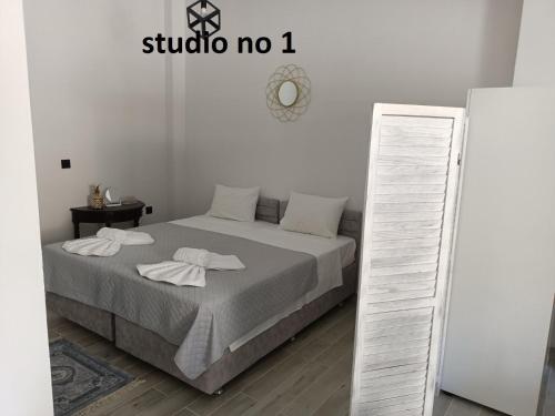 a bedroom with a bed with two towels on it at Evestudioskos in Kos Town