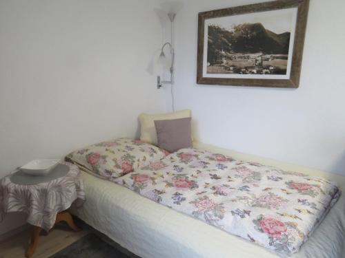 a bed with a quilt on it in a room at Haus Stefan in Oetz
