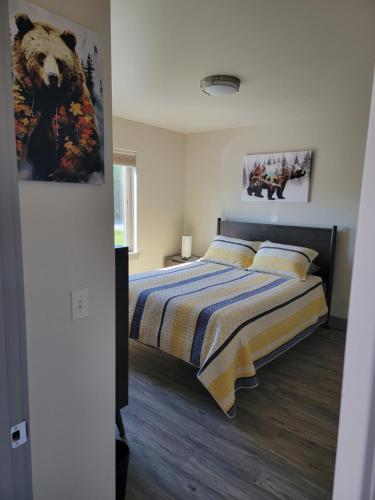 a bedroom with a bed and a painting on the wall at Lakeshore Lodging Suites in Homer