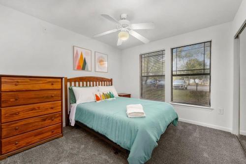 a bedroom with a bed and a dresser and a window at Family home near USF in Tampa