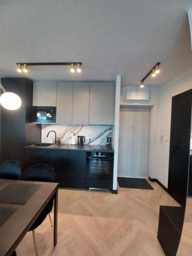 a living room with a kitchen and a table at Jantar Up in Jantar