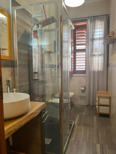 a bathroom with a sink and a glass shower at Green House in Avola