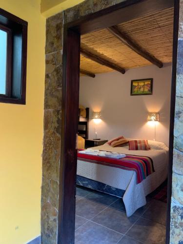 a bedroom with a bed in a room at Posada Tierra Adentro 2 in Purmamarca