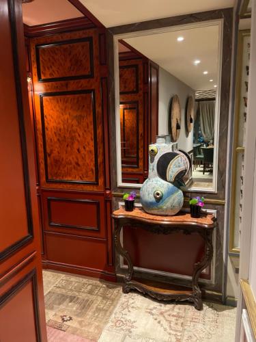 a hallway with a mirror and a vase on a table at Il Relais in Verona
