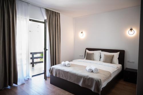 a bedroom with a large bed with towels on it at Evenimente Edelweiss in Bogdan Vodă