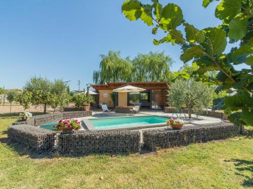 a swimming pool in a yard with a house at Chalet Il Vitigno by Interhome in Sutri
