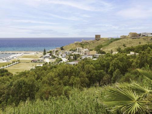 a town on top of a hill next to the ocean at Holiday Home Terrazza del Sud by Interhome in Porto Palo