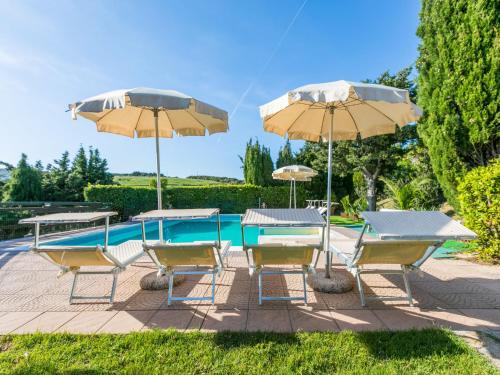 a group of chairs and umbrellas next to a pool at Holiday Home Sea View by Interhome in Castelnuovo della Misericordia