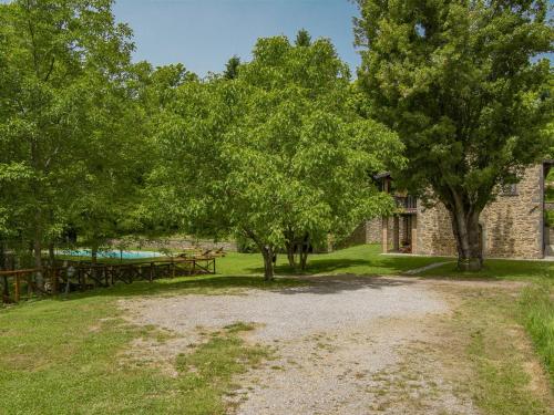 a stone building with trees and a picnic table at Holiday Home La Moscella by Interhome in San Romano in Garfagnana