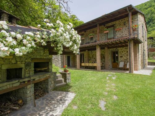 an exterior view of a stone house with a yard at Holiday Home La Moscella by Interhome in San Romano in Garfagnana