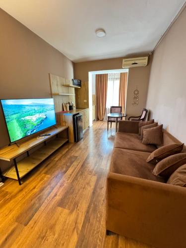a living room with a couch and a flat screen tv at BejartApartment2 in Tirana