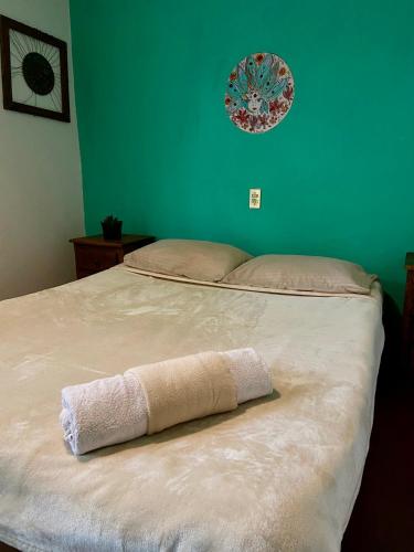 a bed with a towel on it in a bedroom at Hostal Posada Mi Casa in San Cristóbal de Las Casas