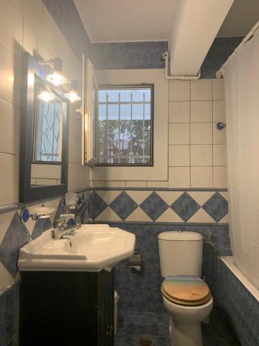 a bathroom with a toilet and a sink at Dori's Seaside Apartment in Athens
