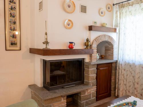 a living room with a brick fireplace with at Villa Rimbaudo by Interhome in Canale Monterano