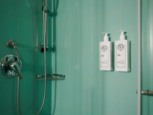 two bottles ofodorizers are on a wall in a bathroom at Hotel Altamira in Orsogna