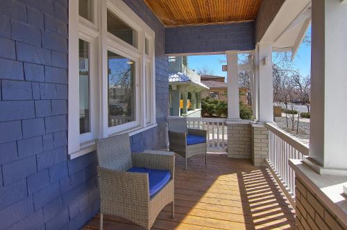 a porch with chairs and windows on a house at Historic Home w/Pikes Peak Views in Colorado Springs