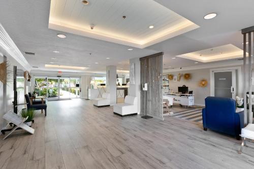 a living room with white furniture and a large ceiling at Holiday Inn Resort Grand Cayman by IHG in George Town