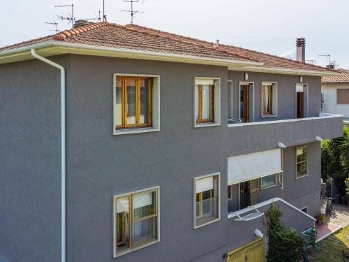 a gray house with windows and a street light at Apartment Casa di Neva by Interhome in Marina di Cecina