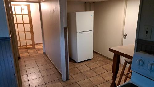 a kitchen with a white refrigerator in a room at Le1226-Private Basement with WIFI and Free Parking in Edmundston