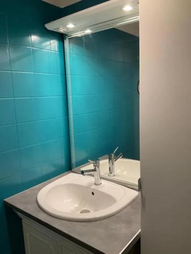 une salle de bain avec un lavabo et un miroir dans l'établissement Appartement moderne à Bagnères-de-Luchon, vue montagne, 53m², à Luchon