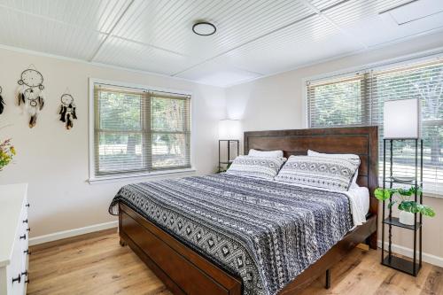 a bedroom with a bed and two windows at Serene Trenton Home with Pool and Mountain Views! in Trenton