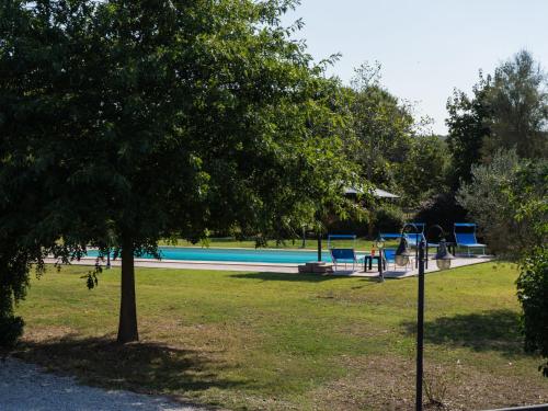 a park with a swimming pool and a playground at Villa Rimbaudo by Interhome in Canale Monterano