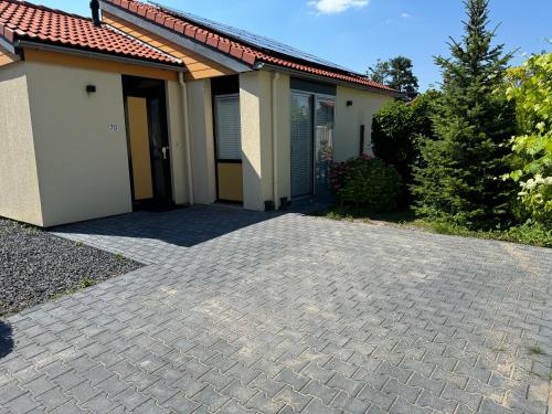 a house with a brick driveway in front of it at Casa Bep in Zevenhuizen