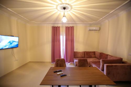 a living room with a couch and a table at Oasis Residence in Vlorë
