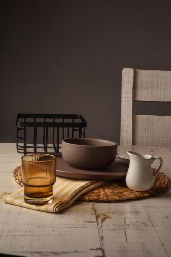 a table with a plate and a bowl and a cup at Casa Raco - Parras de la Fuente in Parras de la Fuente