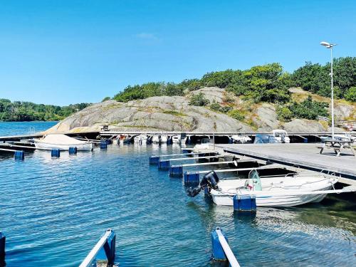 a group of boats docked at a dock in the water at 4 star holiday home in HENÅN in Henån