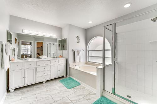 a bathroom with a shower and a tub and a sink at Disney-Themed Villa with Heated Pool, 10 Mi to Parks in Kissimmee