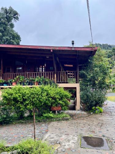 a building with a porch and a sign in front of it at Los Quetzales Ecolodge & Spa in Cerro Punta