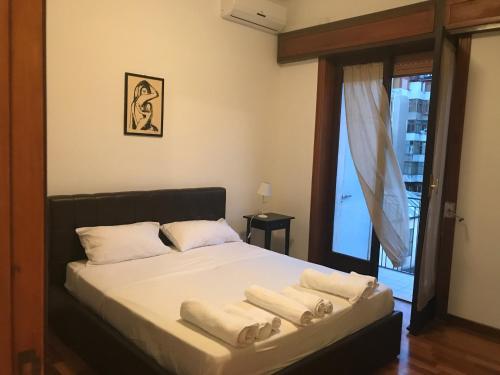 a bedroom with a bed with towels on it at Luxury flat on the heart of Reggio Calabria in Reggio Calabria