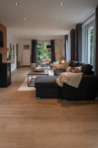 a living room with two couches and a table at Chez Jojo - Gîte rural in Spa