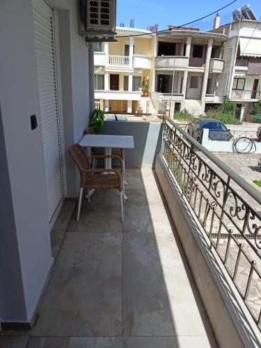 a balcony with a table and a chair on it at George luxury living in Preveza