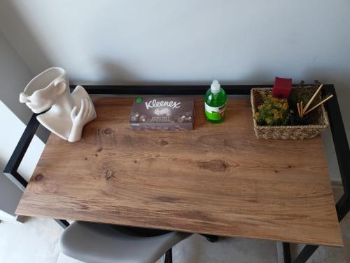 a wooden table with a chair and flowers on it at George luxury living in Preveza