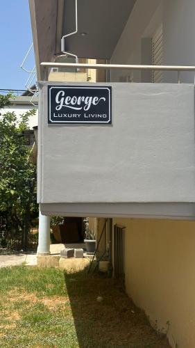 a sign on the side of a building at George luxury living in Preveza