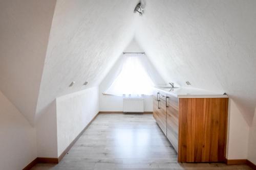 a bathroom with a large window in a attic at Willa Stołowianka- Basen in Bukowina Tatrzańska
